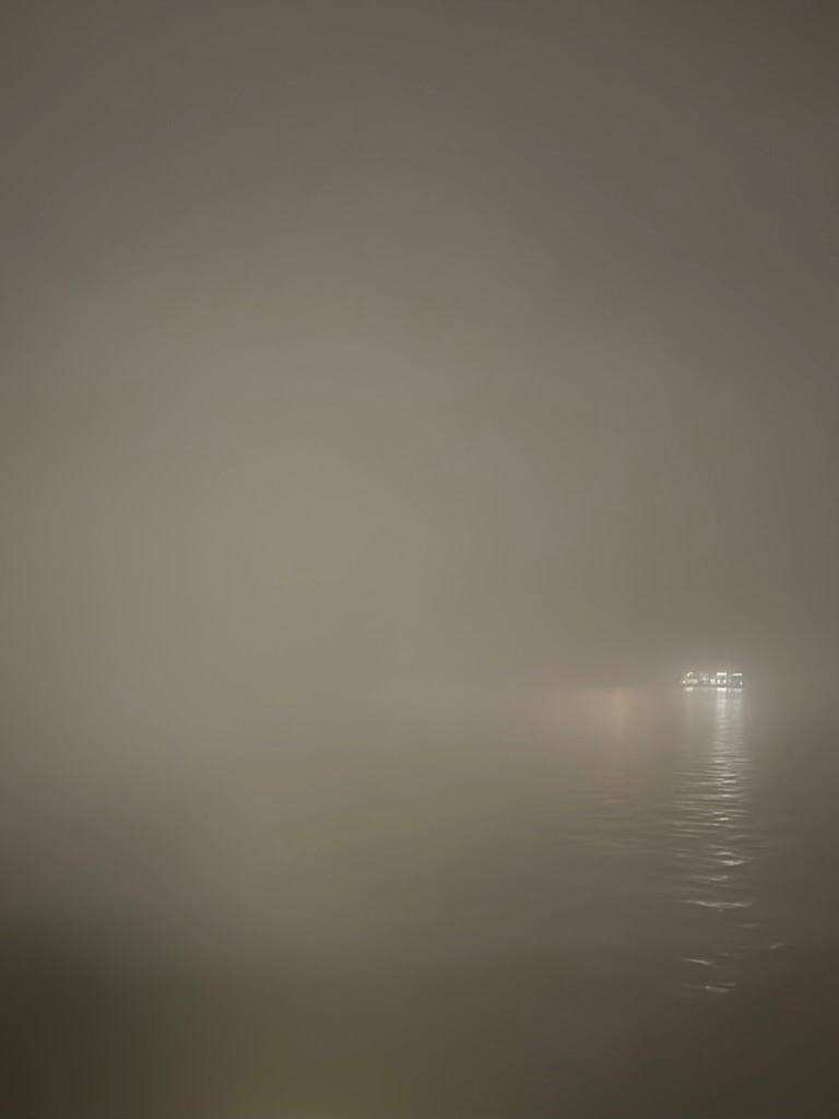Staring out through the fog at the dark waters