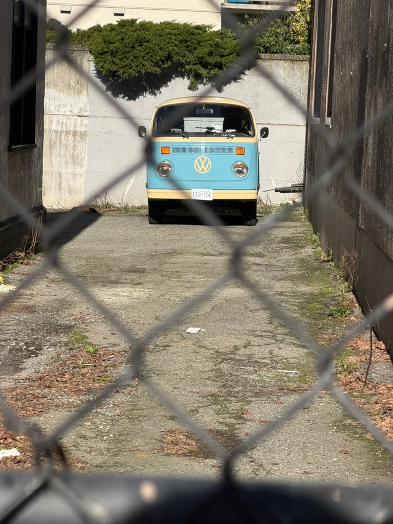 volkswagen van tucked away in an alley, easy to miss