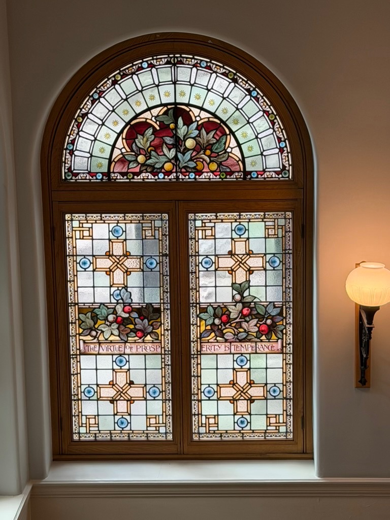 mosaic stained glass with writing 'the virtue of prosperity is temperance'